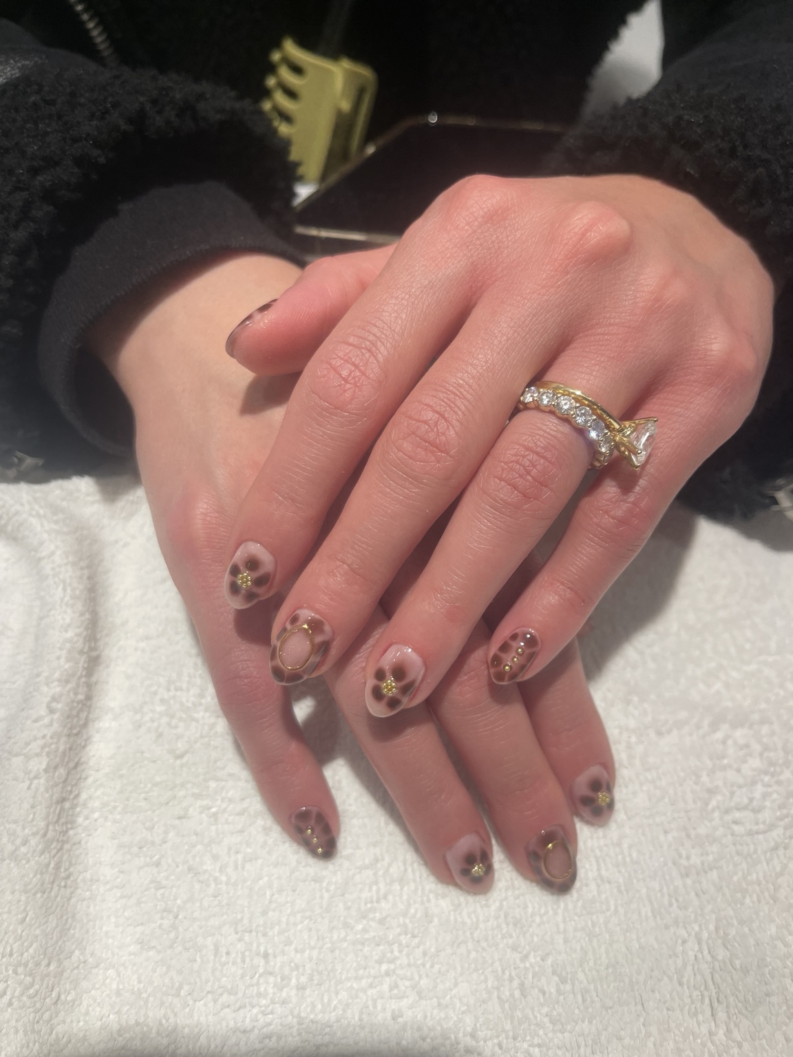 Leopard print nude nail design with gold accents