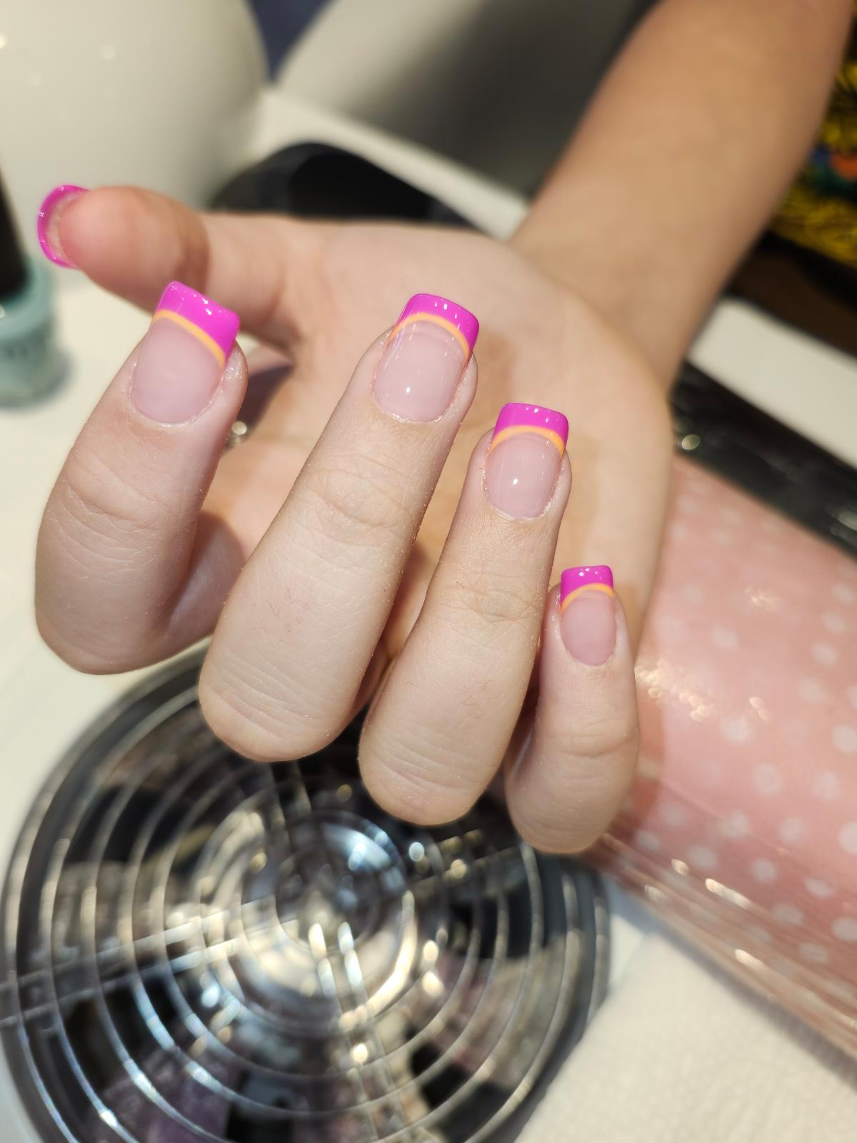 Pink French nails with orange accent line